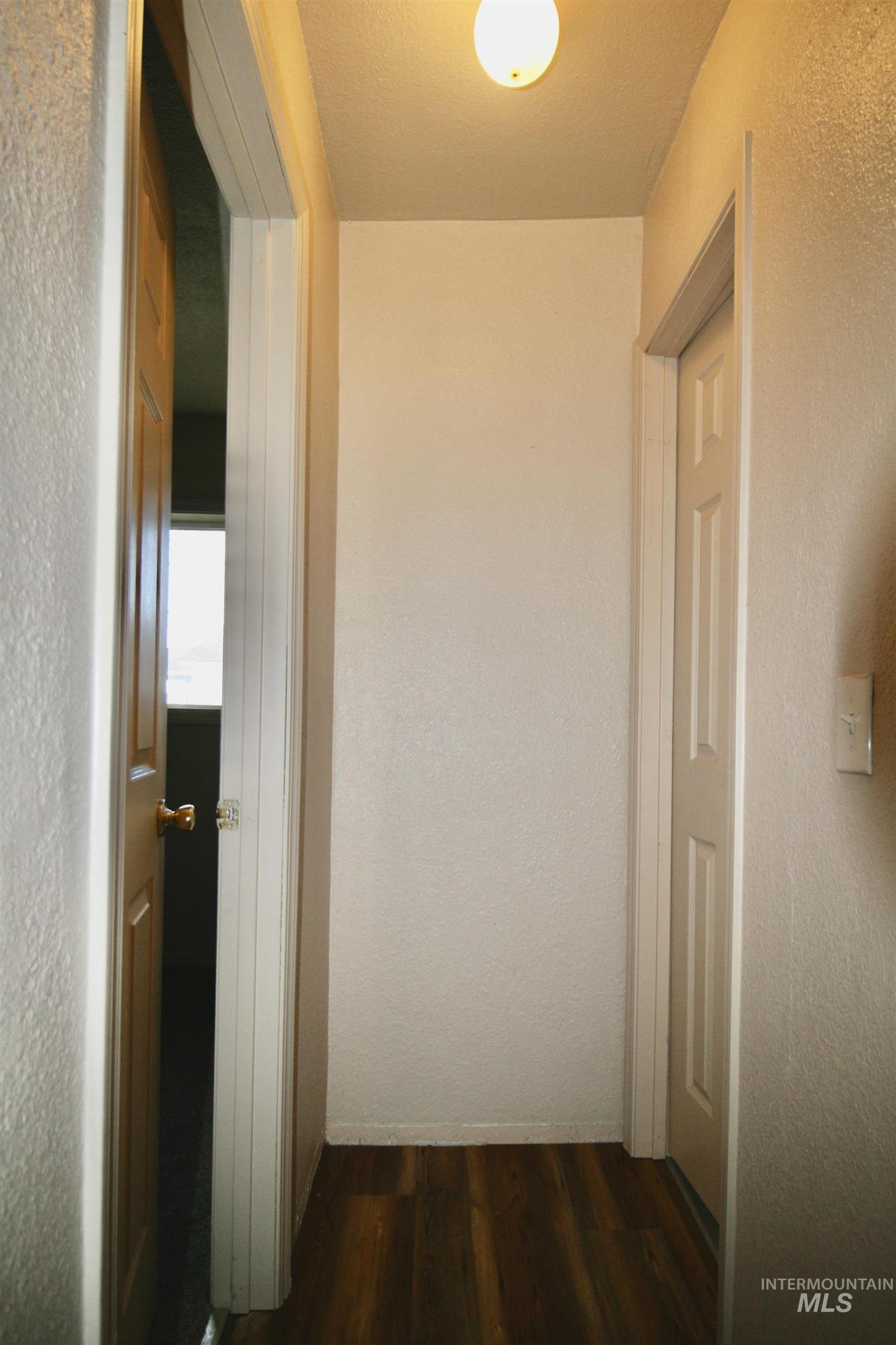 539 North 2nd Street Nyssa, OR 97913 - Photo 14 of 18 Corridor with a textured wall and dark wood-style flooring