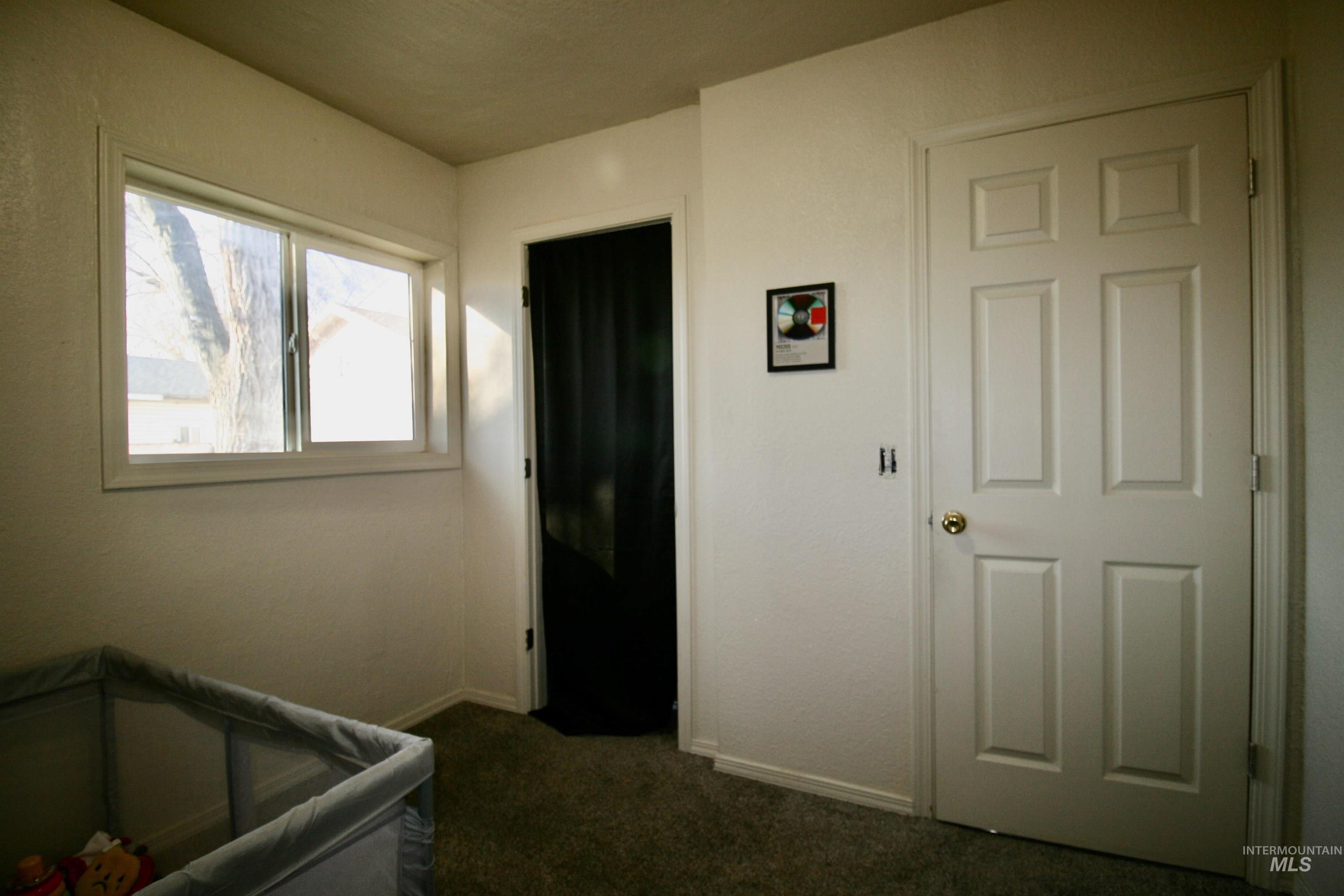 539 North 2nd Street Nyssa, OR 97913 - Photo 16 of 18 Bedroom featuring dark colored carpet and baseboards