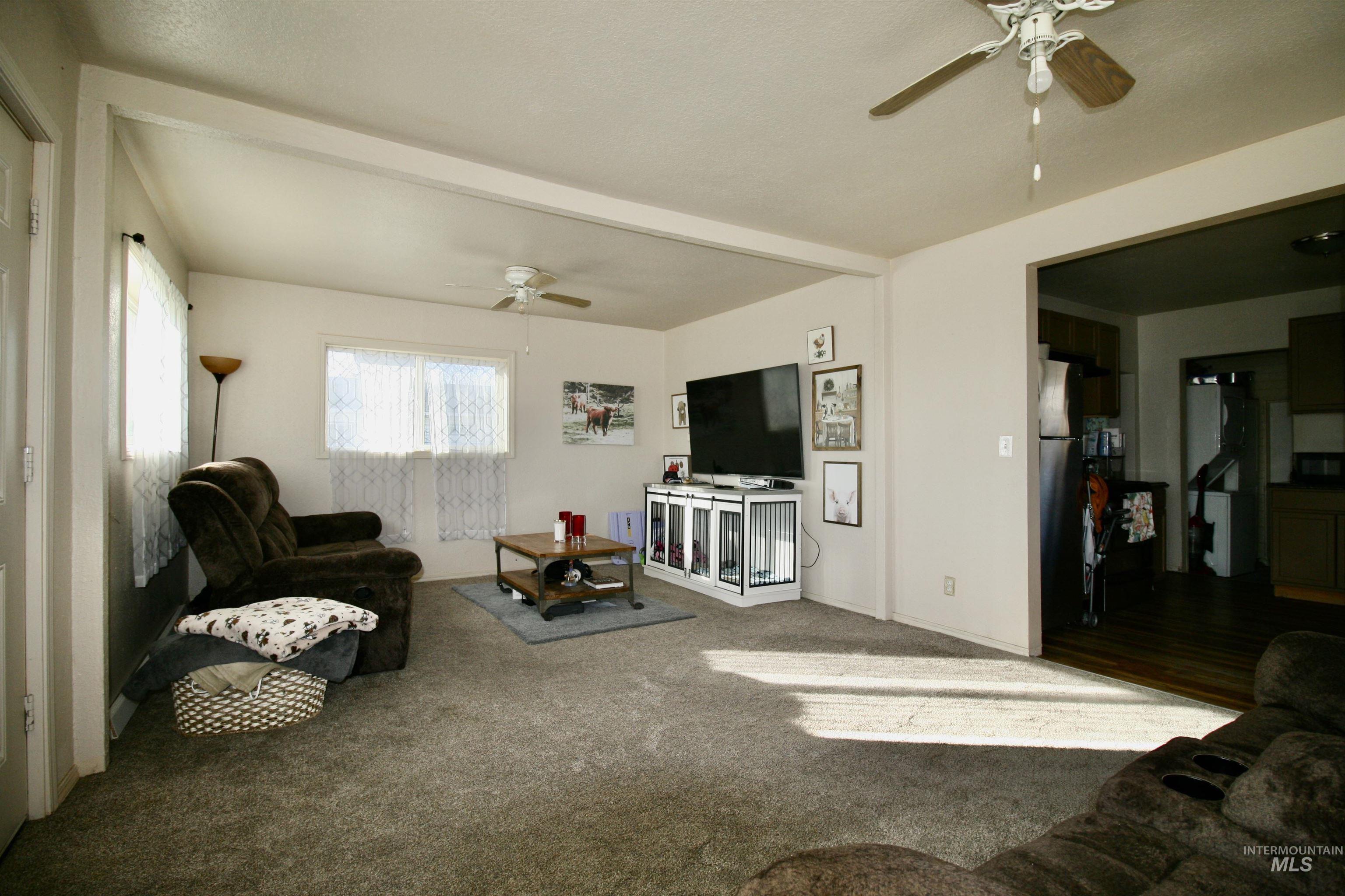 539 North 2nd Street Nyssa, OR 97913 - Photo 6 of 18 Living area featuring ceiling fan and carpet