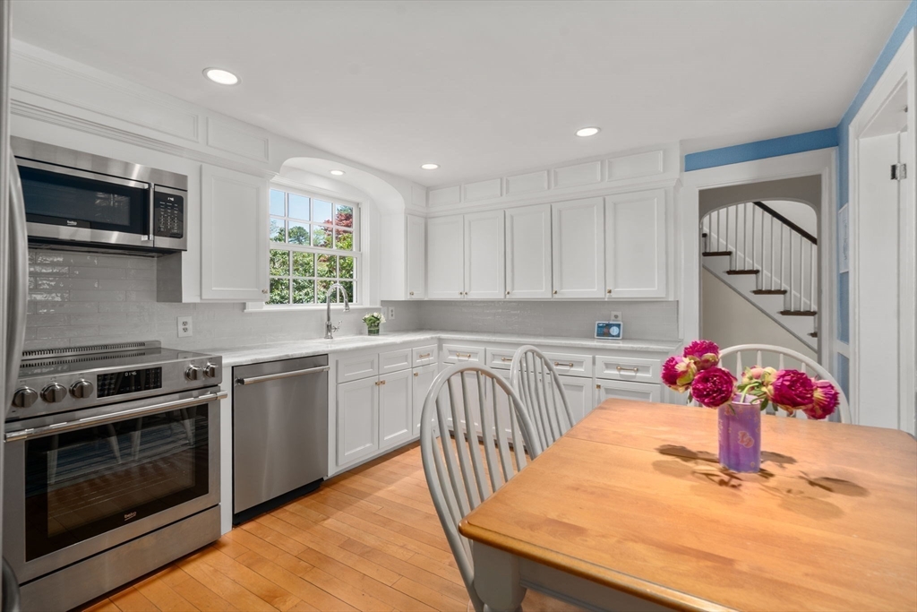 15 Lafayette Circle Wellesley, MA 02482 - Photo 12 of 23 a kitchen with stainless steel appliances granite countertop a kitchen island hardwood floor sink stove and granite counter top