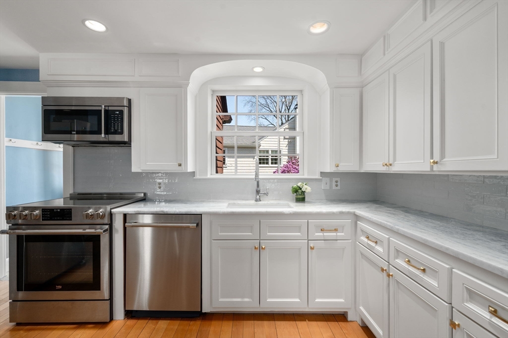 15 Lafayette Circle Wellesley, MA 02482 - Photo 10 of 23 a kitchen with white cabinets and appliances