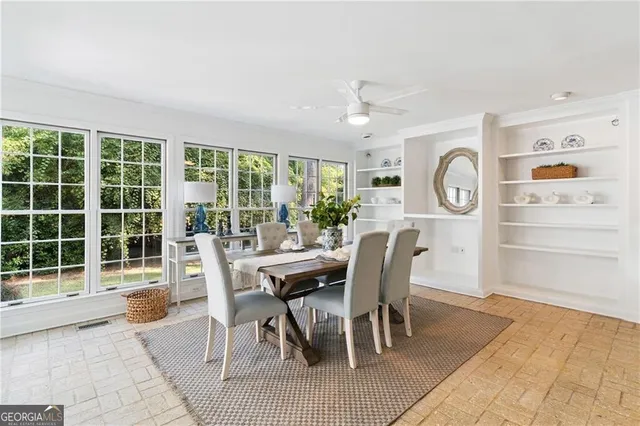 a dining room with furniture and window