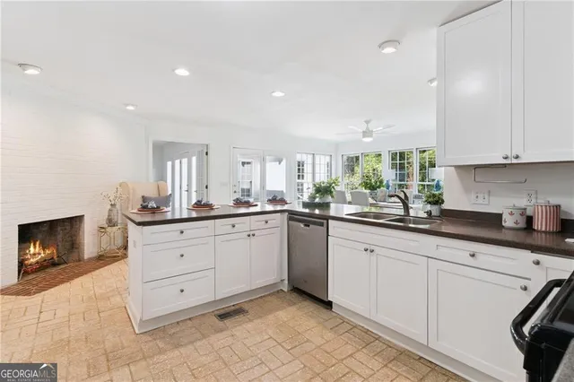 a kitchen with granite countertop white cabinets and white appliances