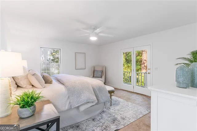 a bedroom with a large bed and potted plant