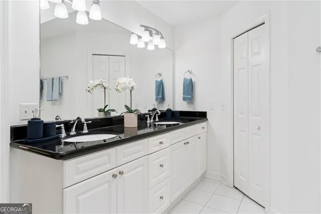 a bathroom with a double vanity sink and a mirror