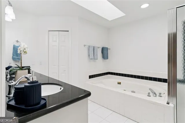 a bathroom with a tub and sink