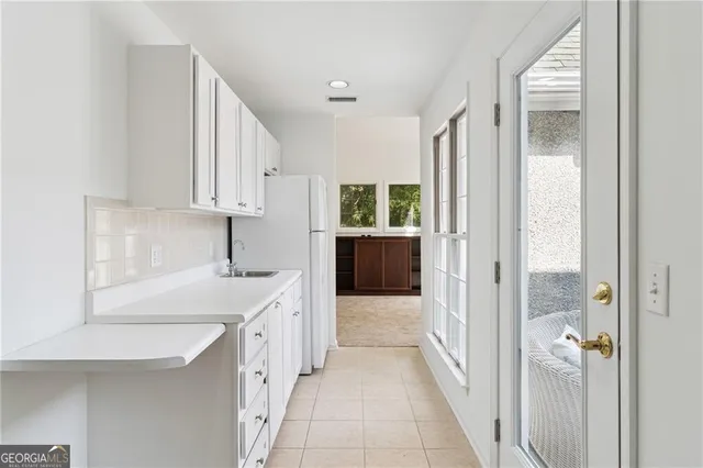 a bathroom with a granite countertop sink a toilet a mirror and shower