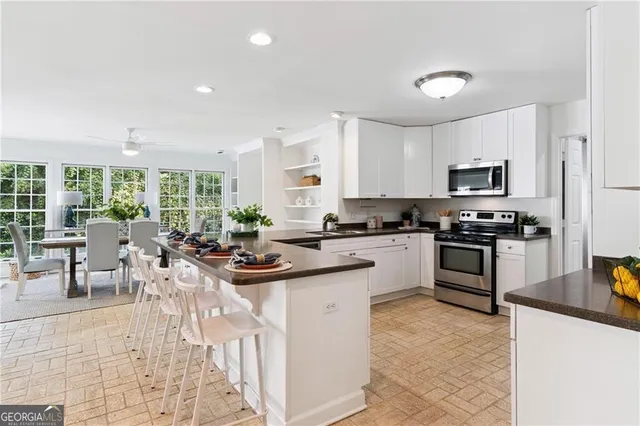 a kitchen with counter space appliances and a dining table