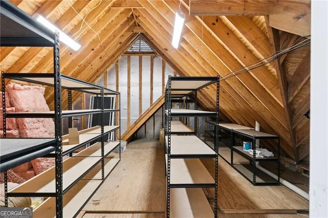 a view of a hallway with wooden floor and entryway