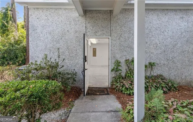 a front view of a house with a yard and glass windows