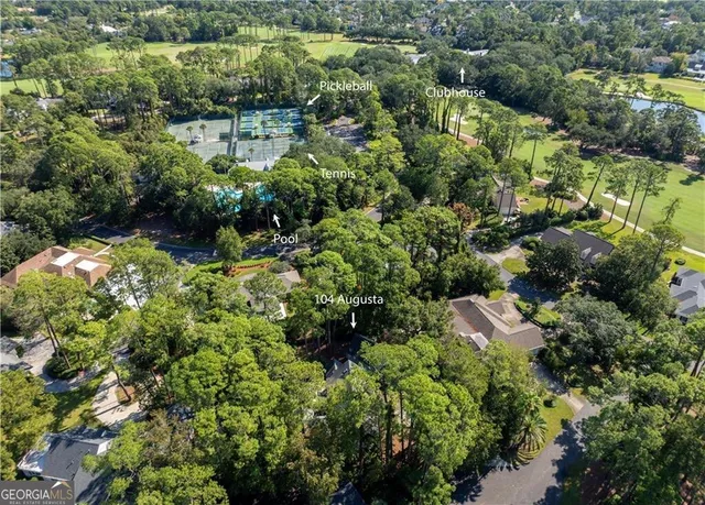 an aerial view of residential house with outdoor space and trees around