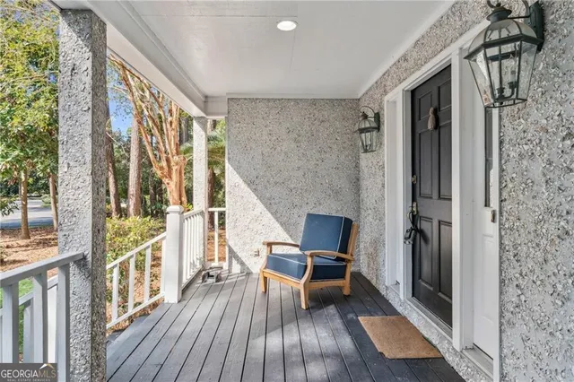 a view of balcony with furniture and wooden floor