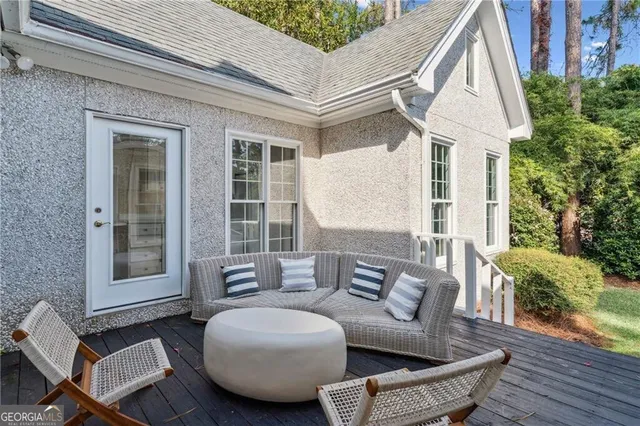 a view of a patio with couches table and chairs and potted plants