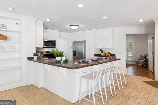 a kitchen with stainless steel appliances kitchen island granite countertop a sink and cabinets