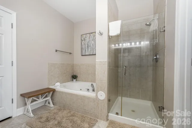 a bedroom with a bed couch and a window