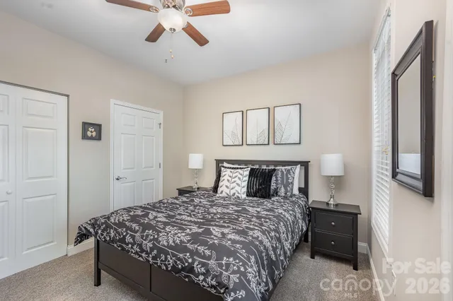 a bedroom with a bed a window and a desk