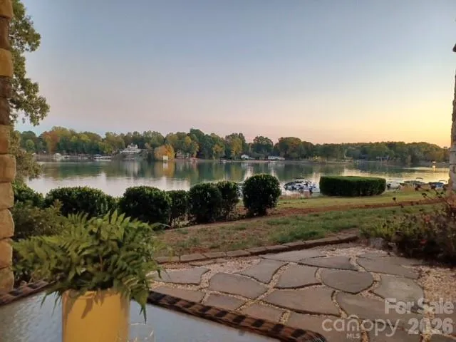 a view of a lake with houses in the back