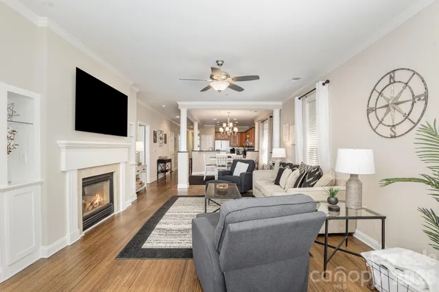 a living room with furniture a fireplace and a flat screen tv
