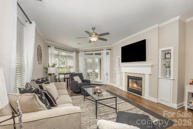 a living room with furniture a fireplace and a flat screen tv