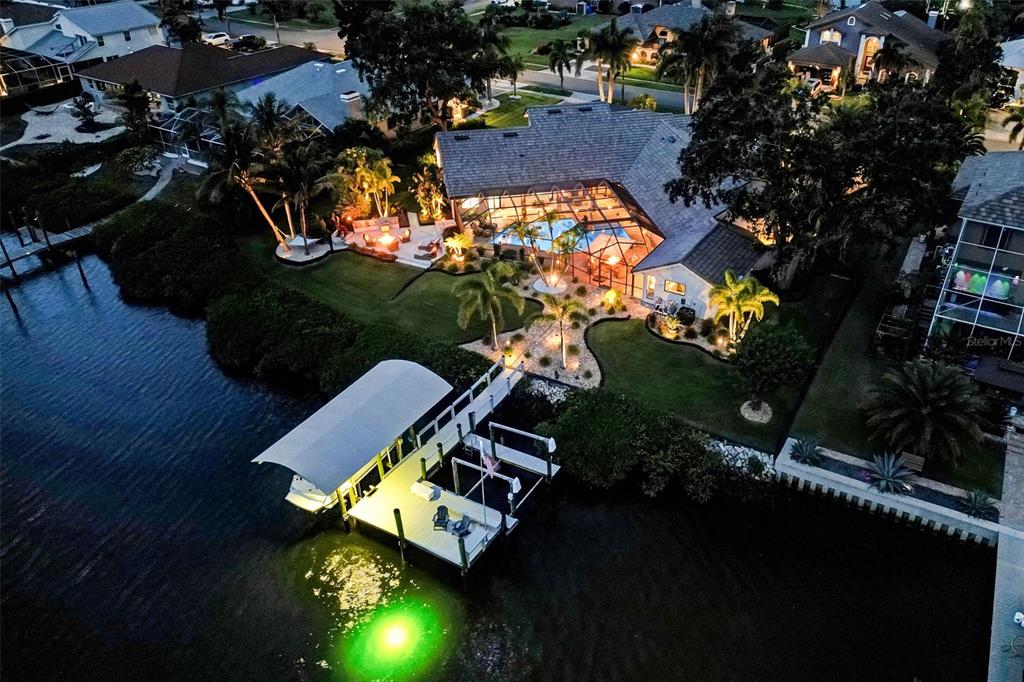 an aerial view of a house with garden space and street view