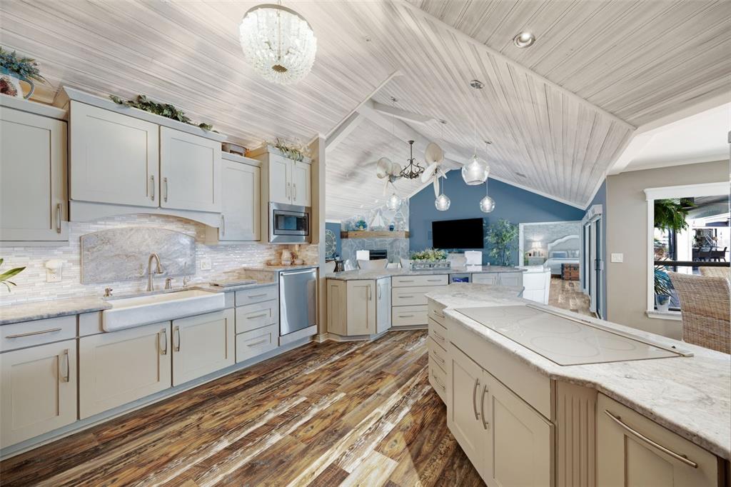 6605 Seabird Way Apollo Beach, FL 33572 - Photo 16 of 52 a large kitchen with a large counter space a sink stainless steel appliances and cabinets