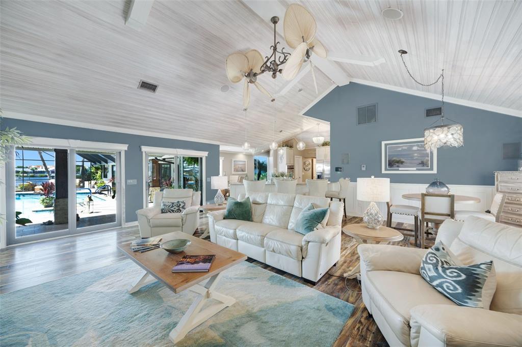 6605 Seabird Way Apollo Beach, FL 33572 - Photo 17 of 52 a living room with furniture chandelier and view of kitchen