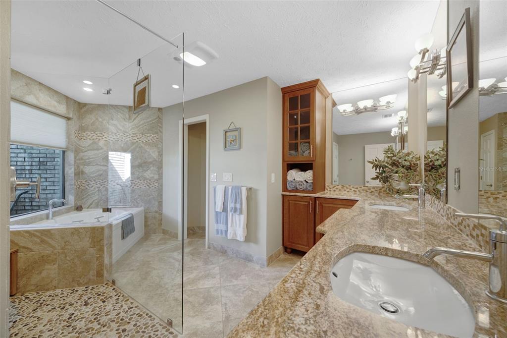 6605 Seabird Way Apollo Beach, FL 33572 - Photo 23 of 52 a bathroom with a granite countertop sink a large mirror and shower
