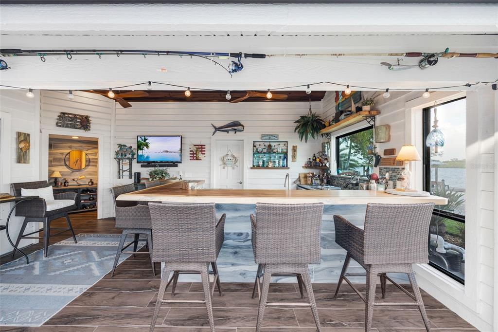 6605 Seabird Way Apollo Beach, FL 33572 - Photo 32 of 52 a dining hall with stainless steel appliances kitchen island granite countertop a table and chairs in it