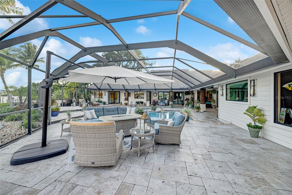 6605 Seabird Way Apollo Beach, FL 33572 - Photo 37 of 52 a view of a patio with table and chairs under an umbrella
