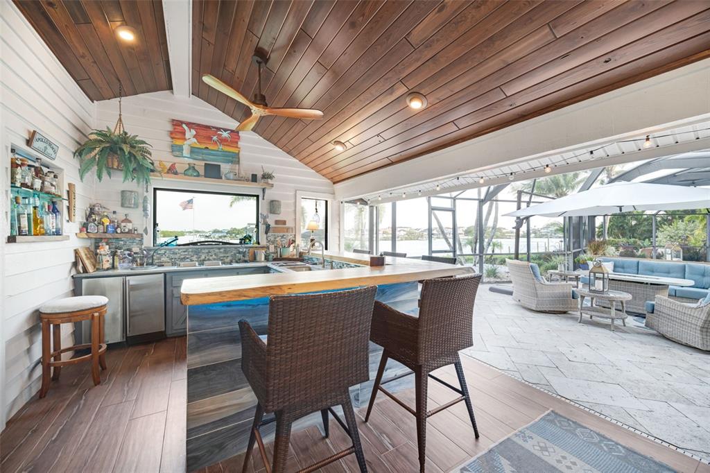 6605 Seabird Way Apollo Beach, FL 33572 - Photo 8 of 52 a kitchen with stainless steel appliances granite countertop sink stove and wooden cabinets