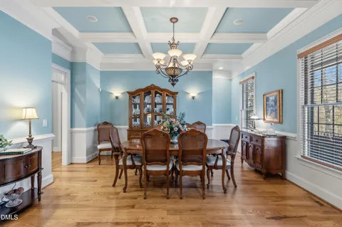 a view of a dining room with furniture and chandelier