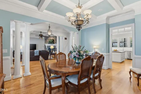 a view of a dining room with furniture wooden floor and chandelier