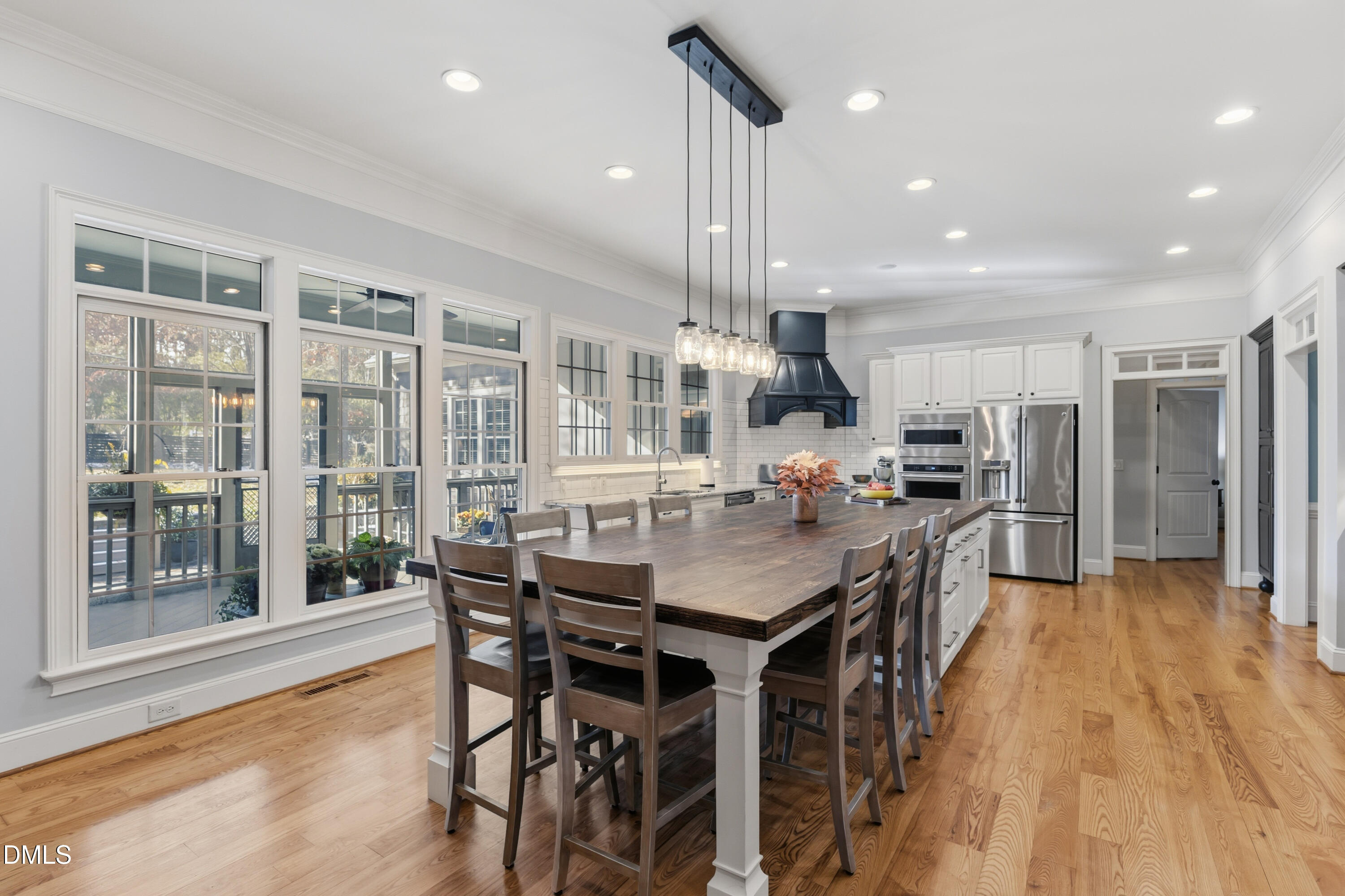 1709 Colombard Court Wake Forest, NC 27587 - Photo 15 of 49 a kitchen with stainless steel appliances kitchen island granite countertop a table chairs and a refrigerator