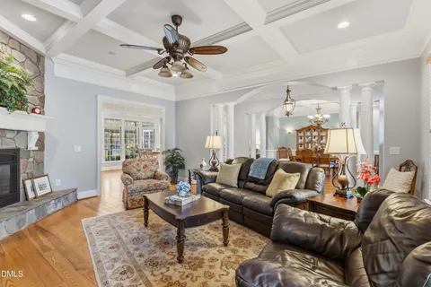 a living room with furniture a ceiling fan and a rug