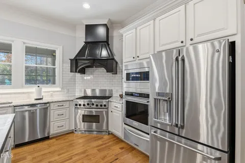 a kitchen with stainless steel appliances a stove sink and microwave