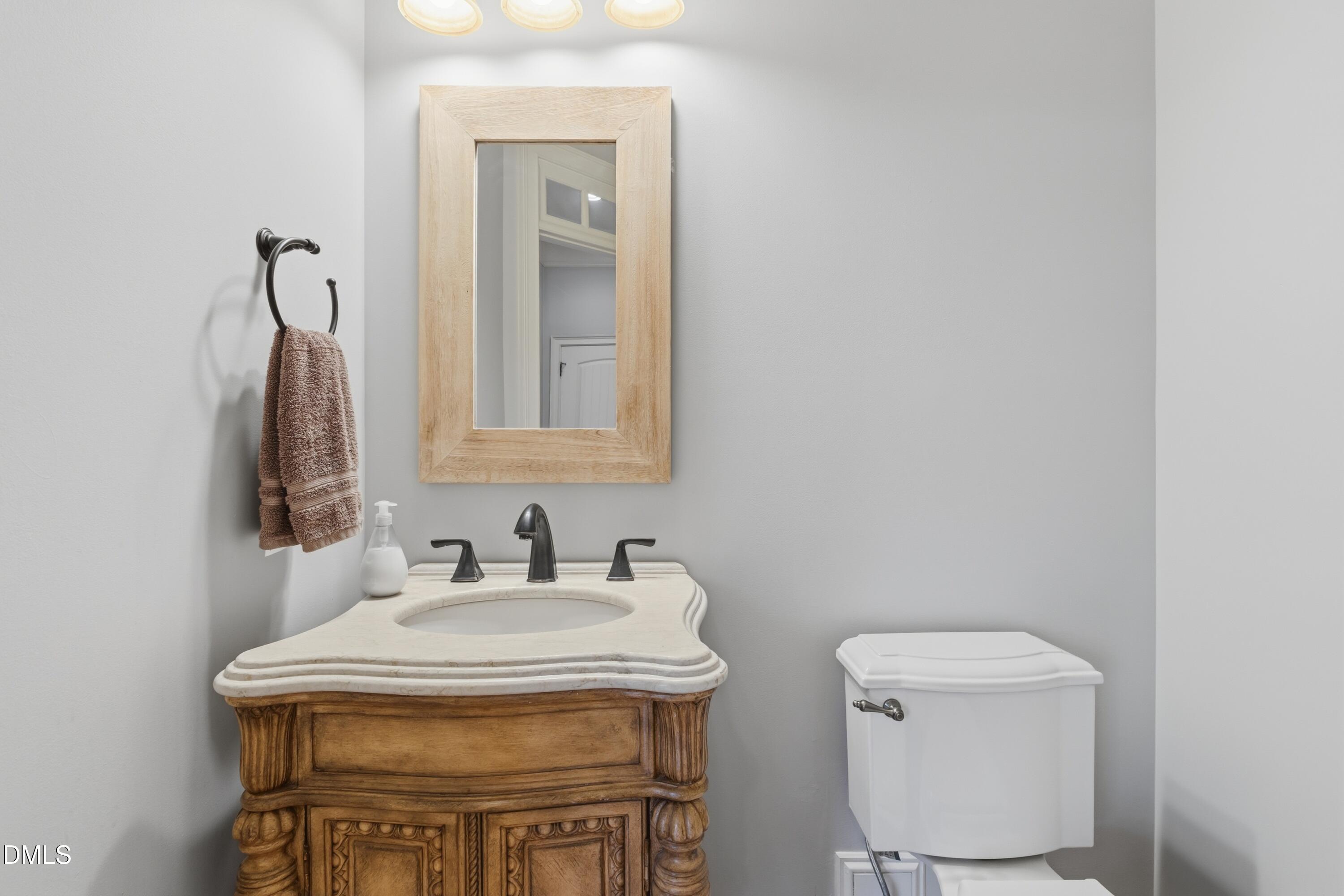 1709 Colombard Court Wake Forest, NC 27587 - Photo 20 of 49 a bathroom with a toilet a sink and mirror