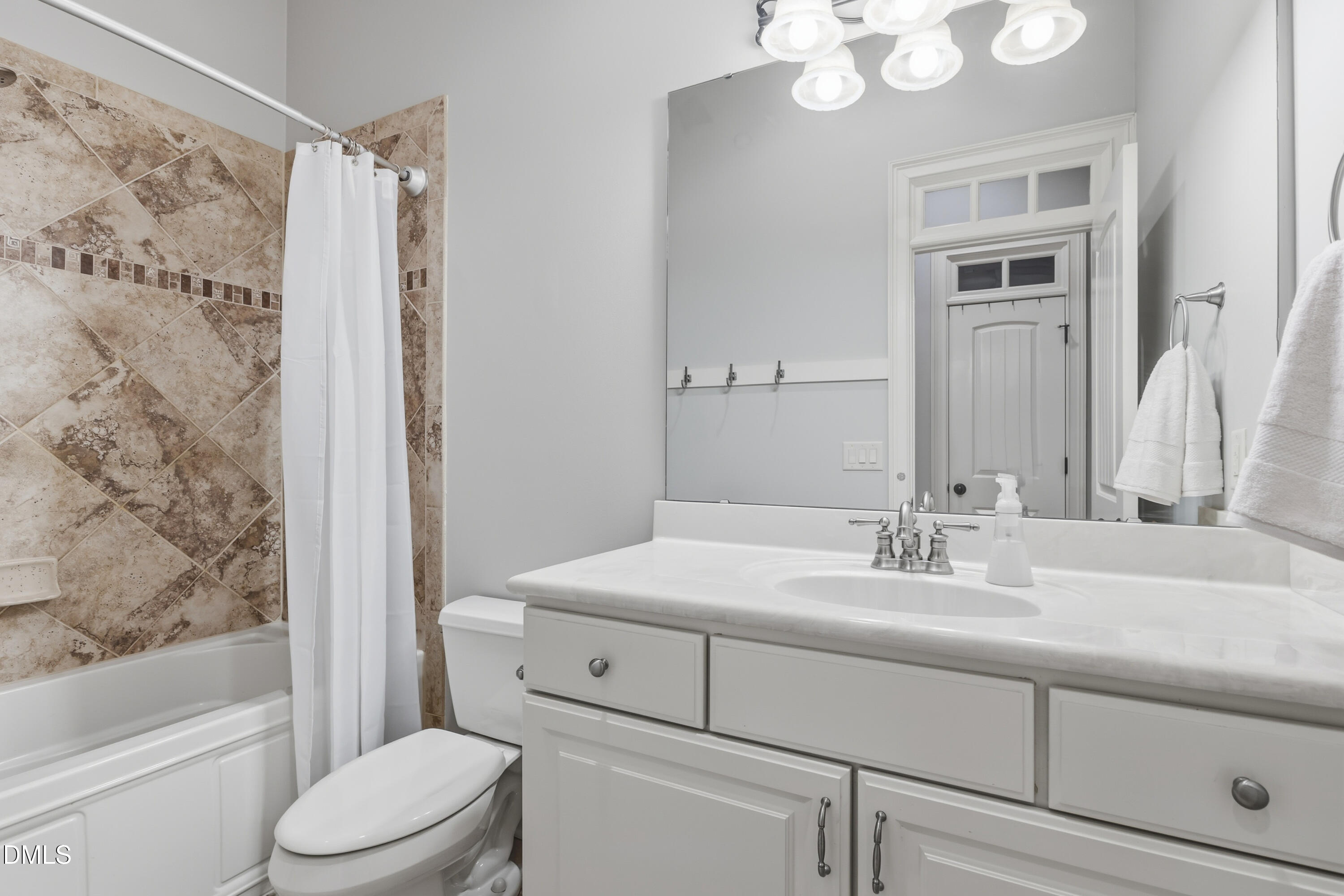 1709 Colombard Court Wake Forest, NC 27587 - Photo 22 of 49 a bathroom with a sink a toilet and shower