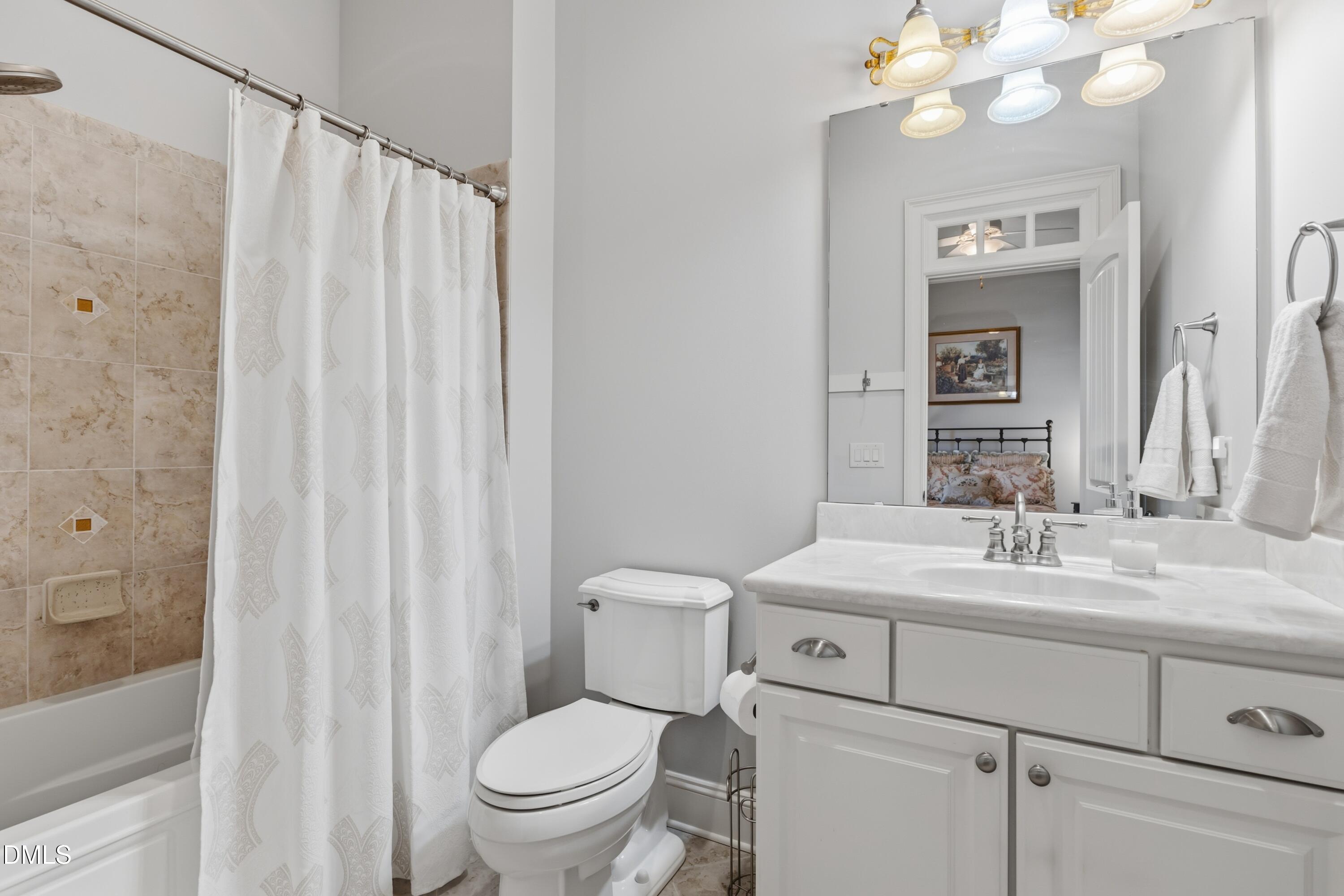 1709 Colombard Court Wake Forest, NC 27587 - Photo 27 of 49 a bathroom with a sink a toilet and a mirror