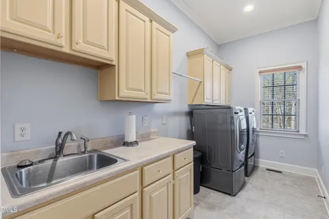 a kitchen with a refrigerator and a sink