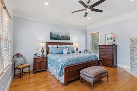 a bedroom with a bed dresser and a window