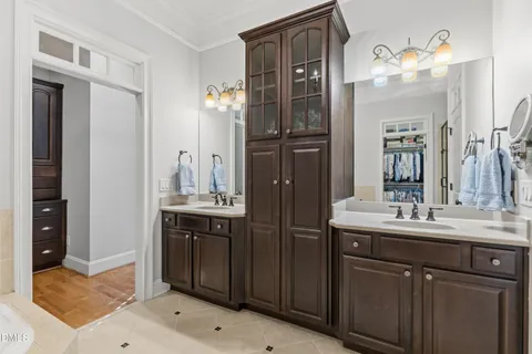 a bathroom with a double vanity sink and a mirror