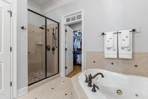a bathroom with a tub sink and shower