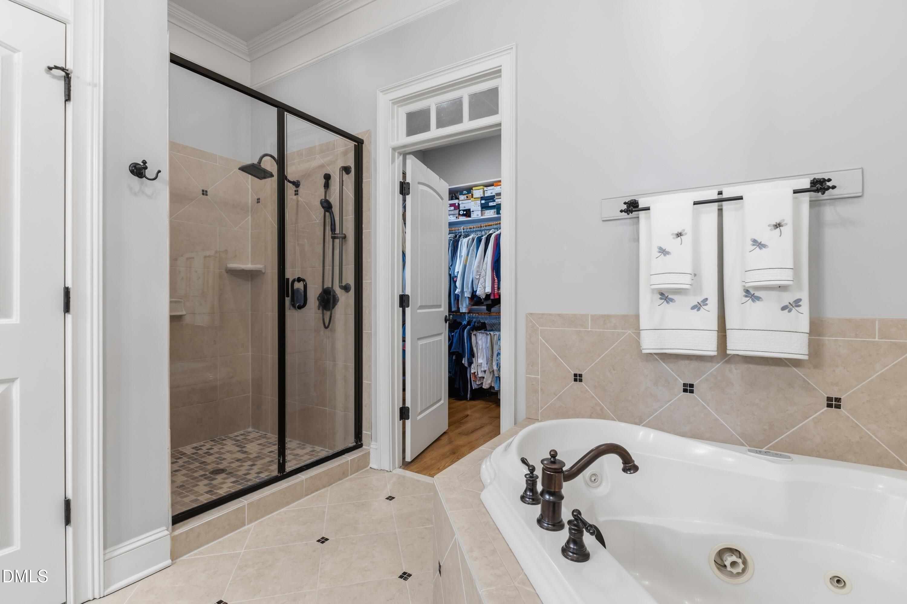 1709 Colombard Court Wake Forest, NC 27587 - Photo 34 of 49 a bathroom with a tub sink and shower