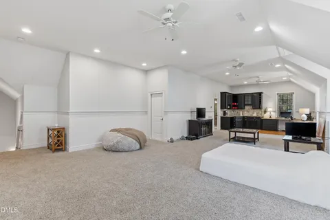 a living room with furniture and kitchen view