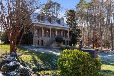 a view of a house with yard and tree s