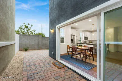 a view of a hallway with dining area and chandelier