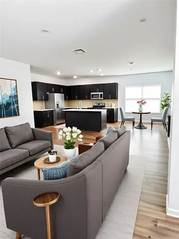 a living room with furniture kitchen view and a large window