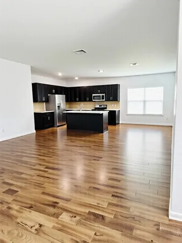a view of kitchen with microwave and cabinets