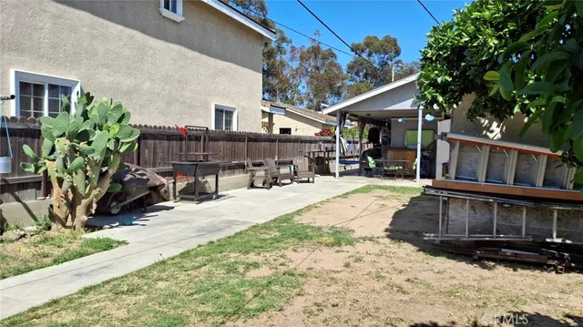 a view of a house with a yard covered with snow in the background