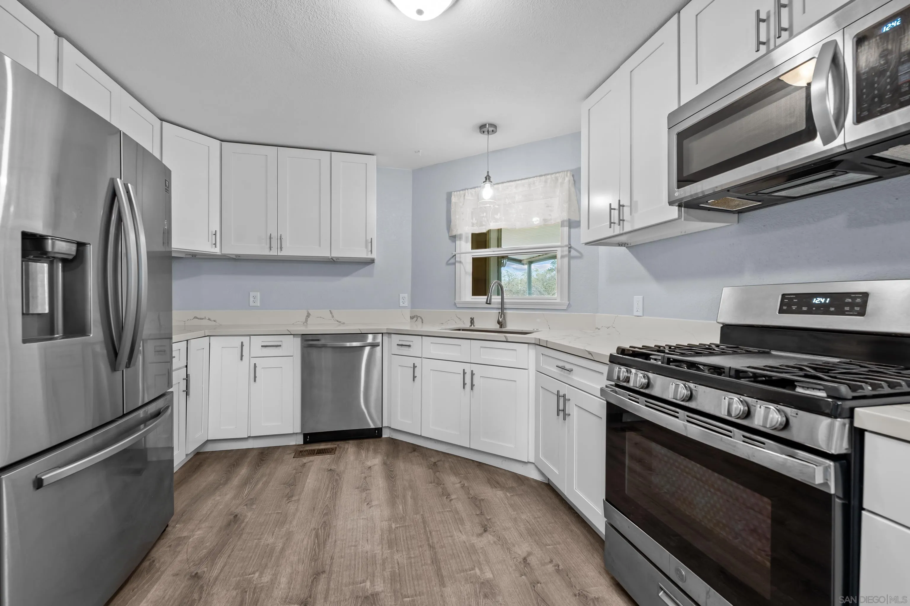 18218 Paradise Mountain Road, Unit 199 Valley Center, CA 92082 - Photo 17 of 41 Beautifully Remodeled Kitchen with Stainless Appliances and Quartz Counters